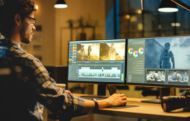 Photo of a video editor working on a project at his desk