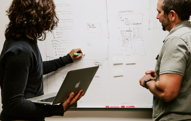 photo of two people using whiteboard
