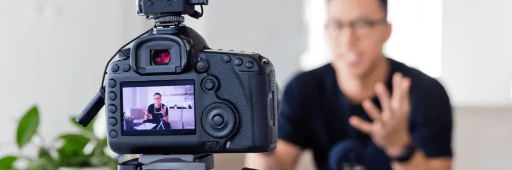 picture of camera recording man speaking into camera